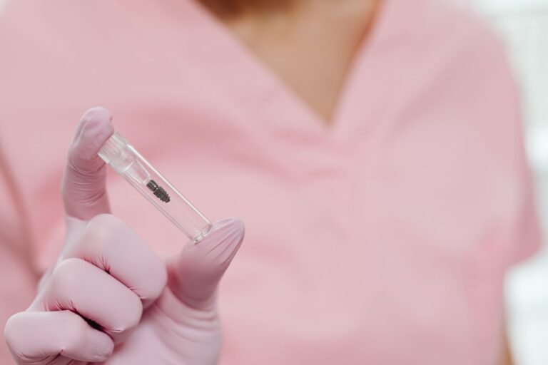 Dental professional holding an implant model in Richmond Hill