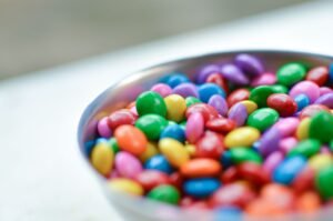 Assorted colourful candies that can trigger tooth pain from sugar sensitivity