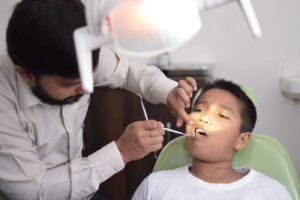 Dentist checking a child's teeth before a fluoride treatment