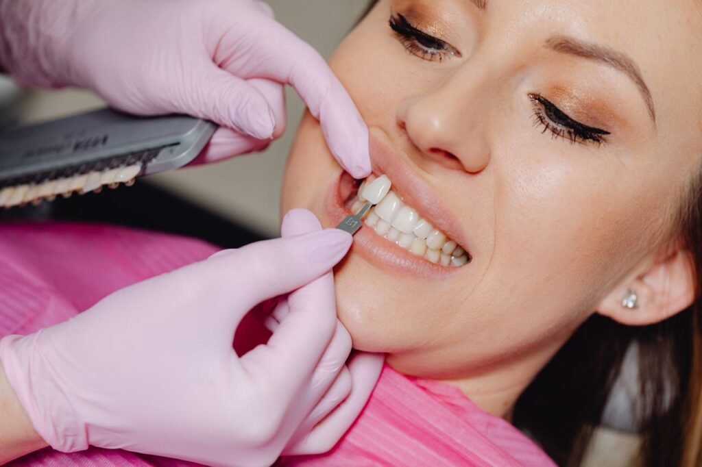 Dentist placing a porcelain veneer on a patient