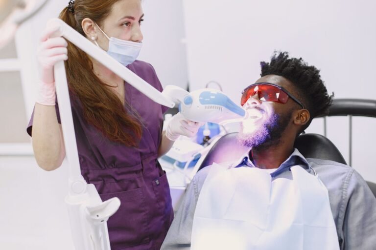 Dentist performing professional teeth whitening on a patient