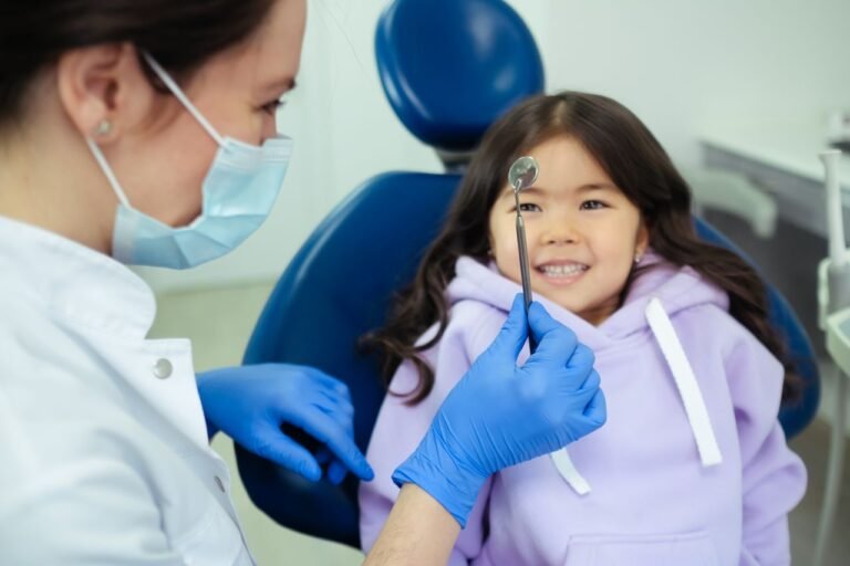 Dentist showing a dental tool to a child during a check-up in Richmond Hill